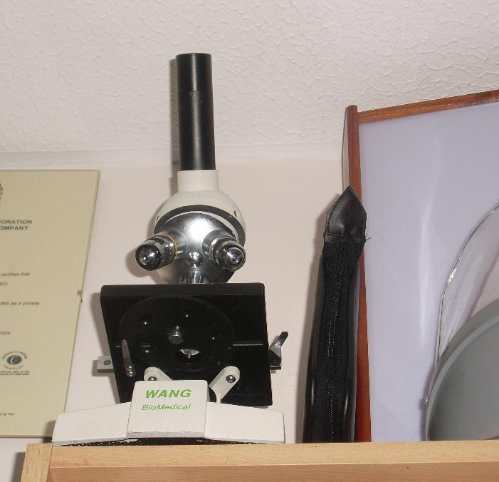 Microscope with lenses angled as if it is watching the viewer